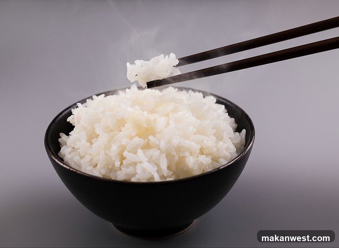 Bowl of Steaming White Rice with Chopsticks