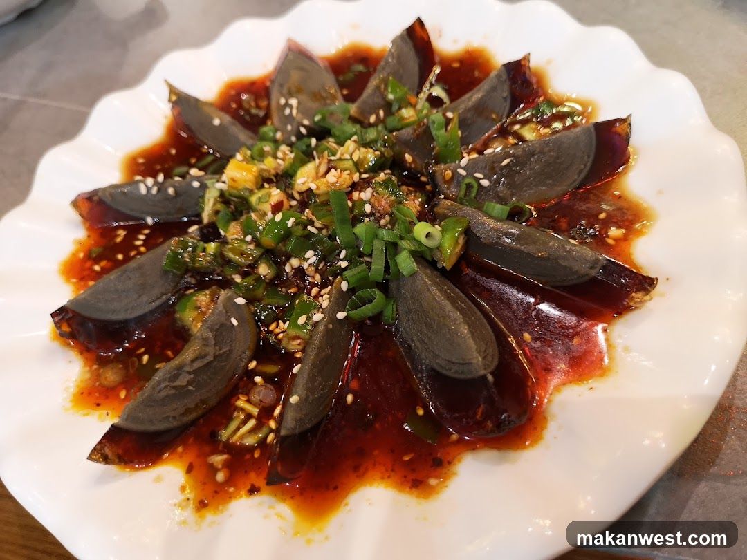 Dish with dark jelly-like slices in sauce