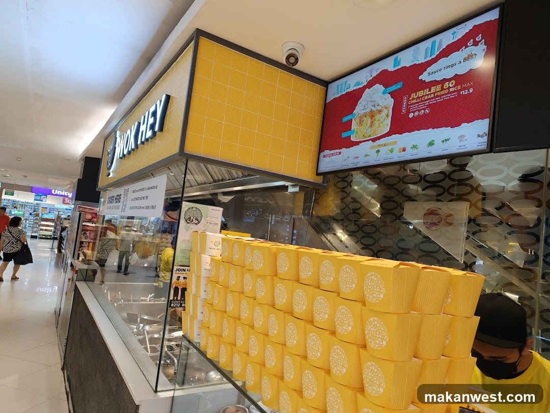 Food stall with yellow boxes and menu board