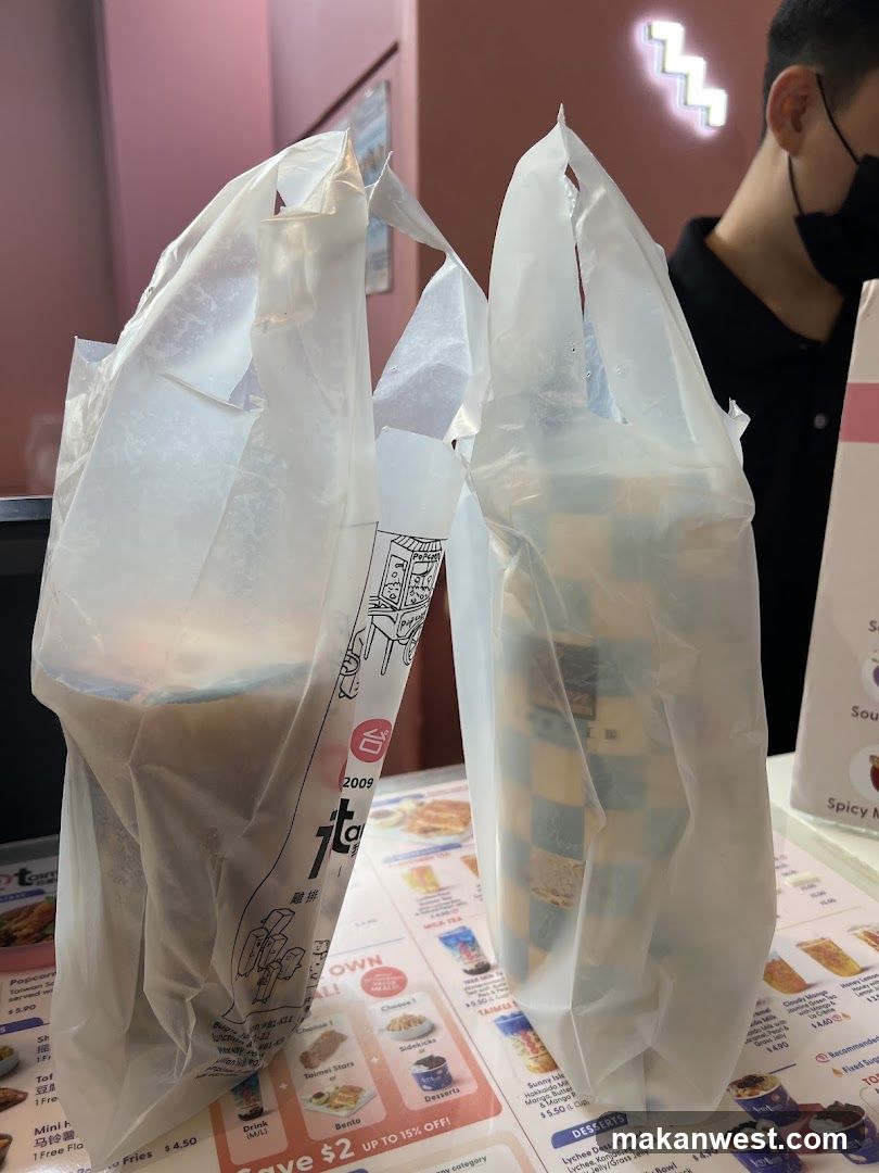 Takeout bags with food items on table