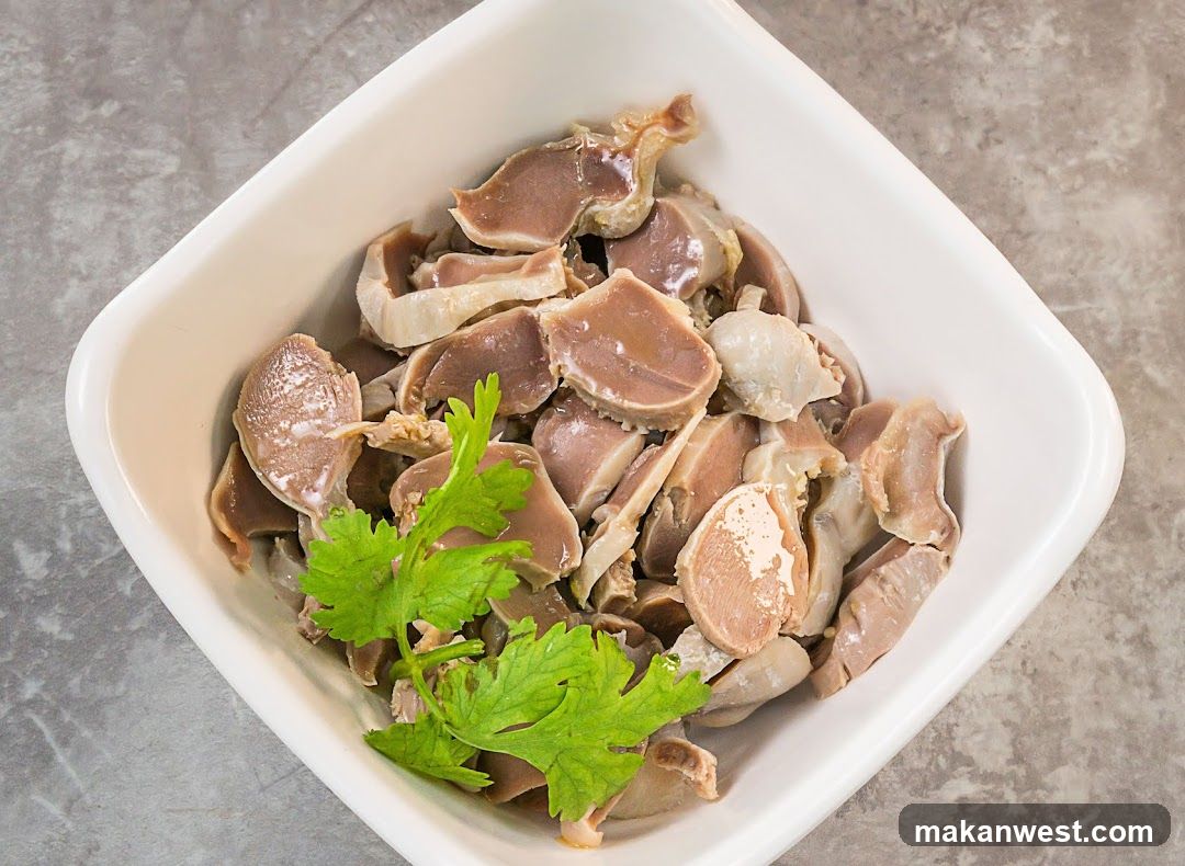 Bowl of cooked offal with cilantro garnish