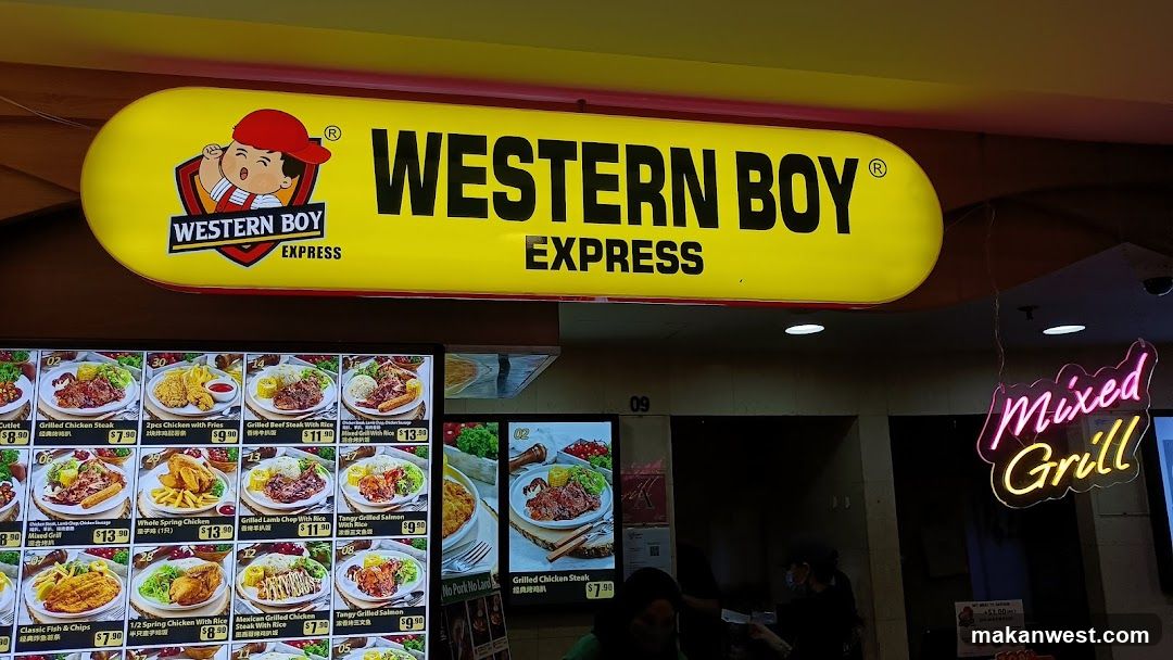 A brightly lit storefront featuring a large yellow sign with the 'WESTERN BOY EXPRESS' logo and mascot. Below, digital menu boards display various dishes like fried chicken, grilled steak, and spring rolls with prices in RM. A neon 'Mixed Grill' sign hangs to the right.