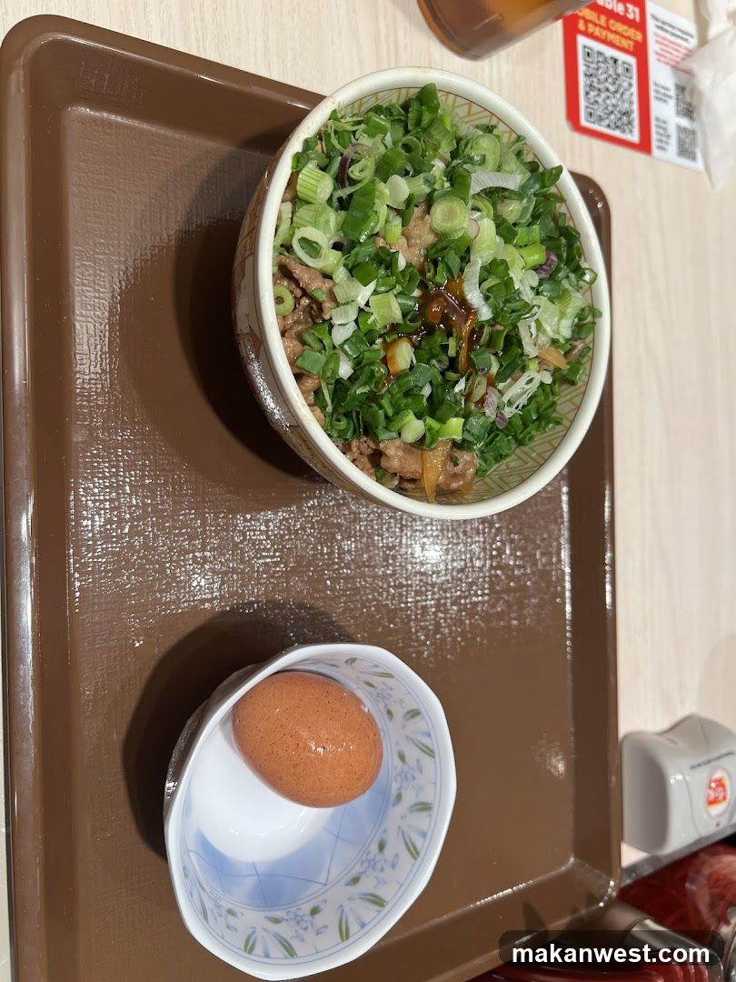 Bowl of food with egg on tray