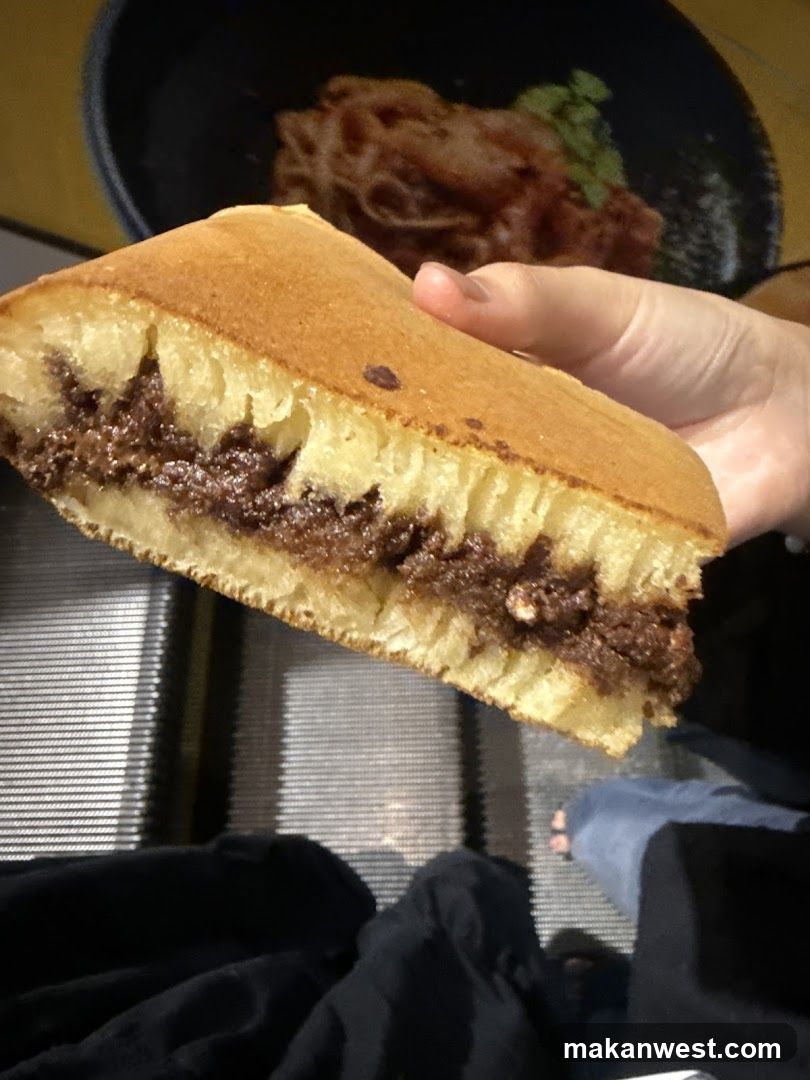 Hand Holding Pastry with Filling