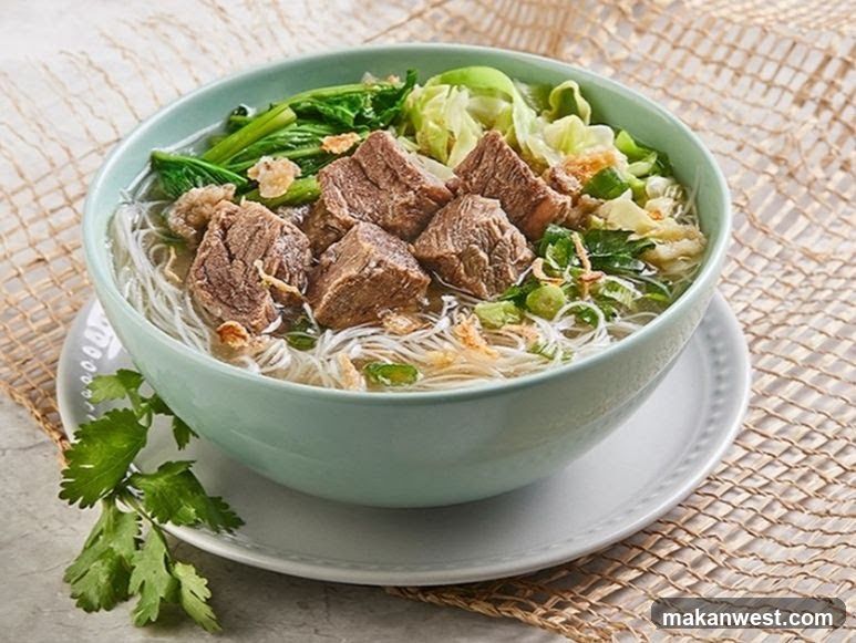 Bowl of Noodle Soup with Meat and Greens