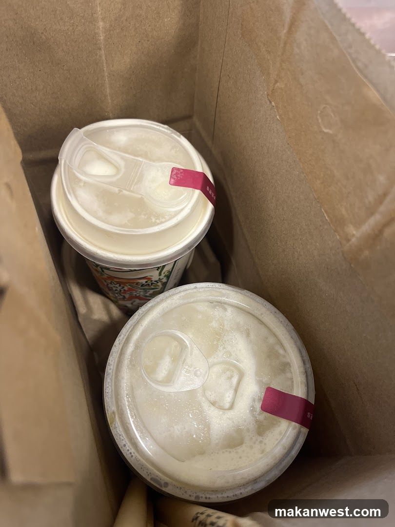Two iced drinks in a paper bag