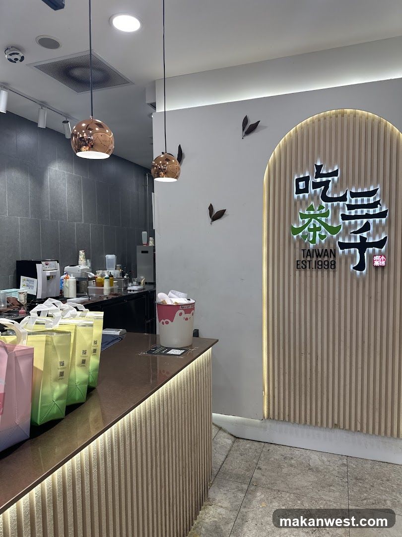 Interior of a tea shop with branded signage and counter display