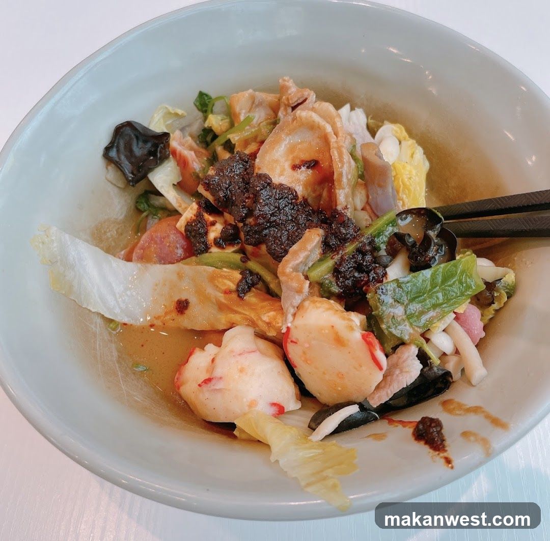 Bowl of mixed noodles with toppings