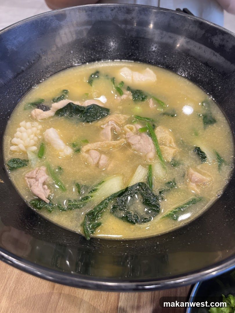 Bowl of Soup with Greens and Meat