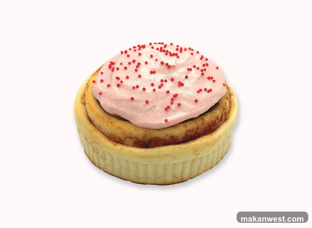 Cinnamon Roll with Pink Frosting and Red Sprinkles
