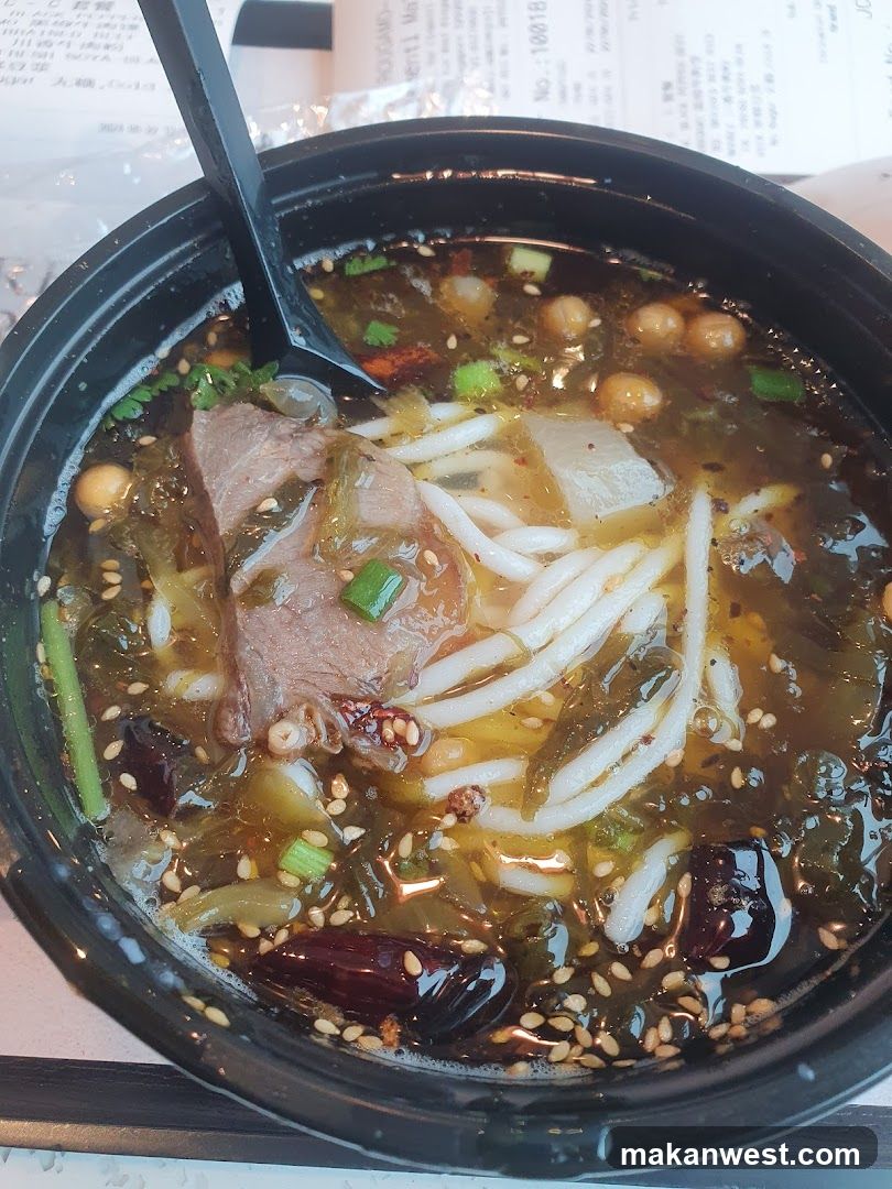 Bowl of Noodle Soup with Meat and Vegetables