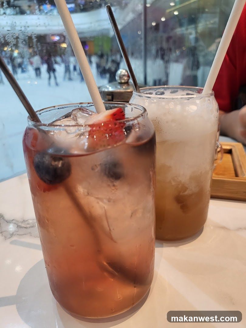Two iced drinks with straws on a table