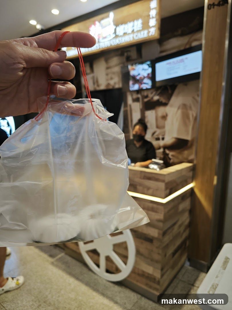 Hand holding plastic bag with food items in front of shop interior
