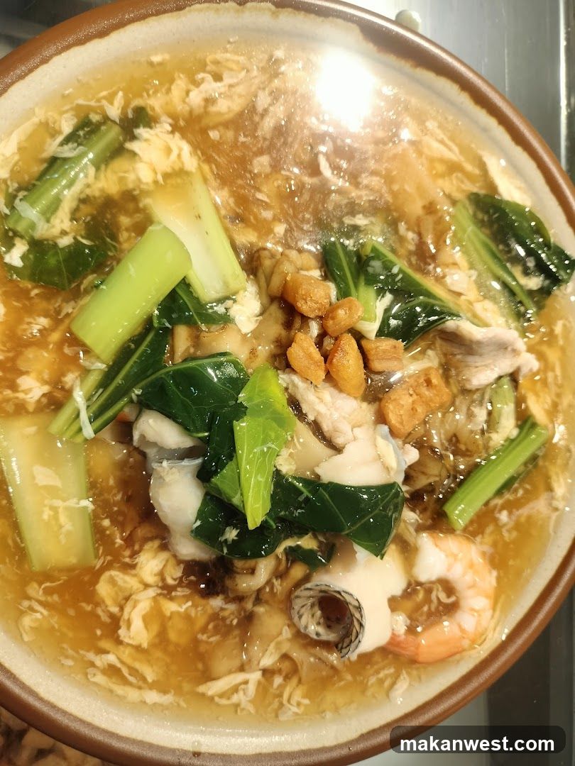 Bowl of Soup with Vegetables and Seafood