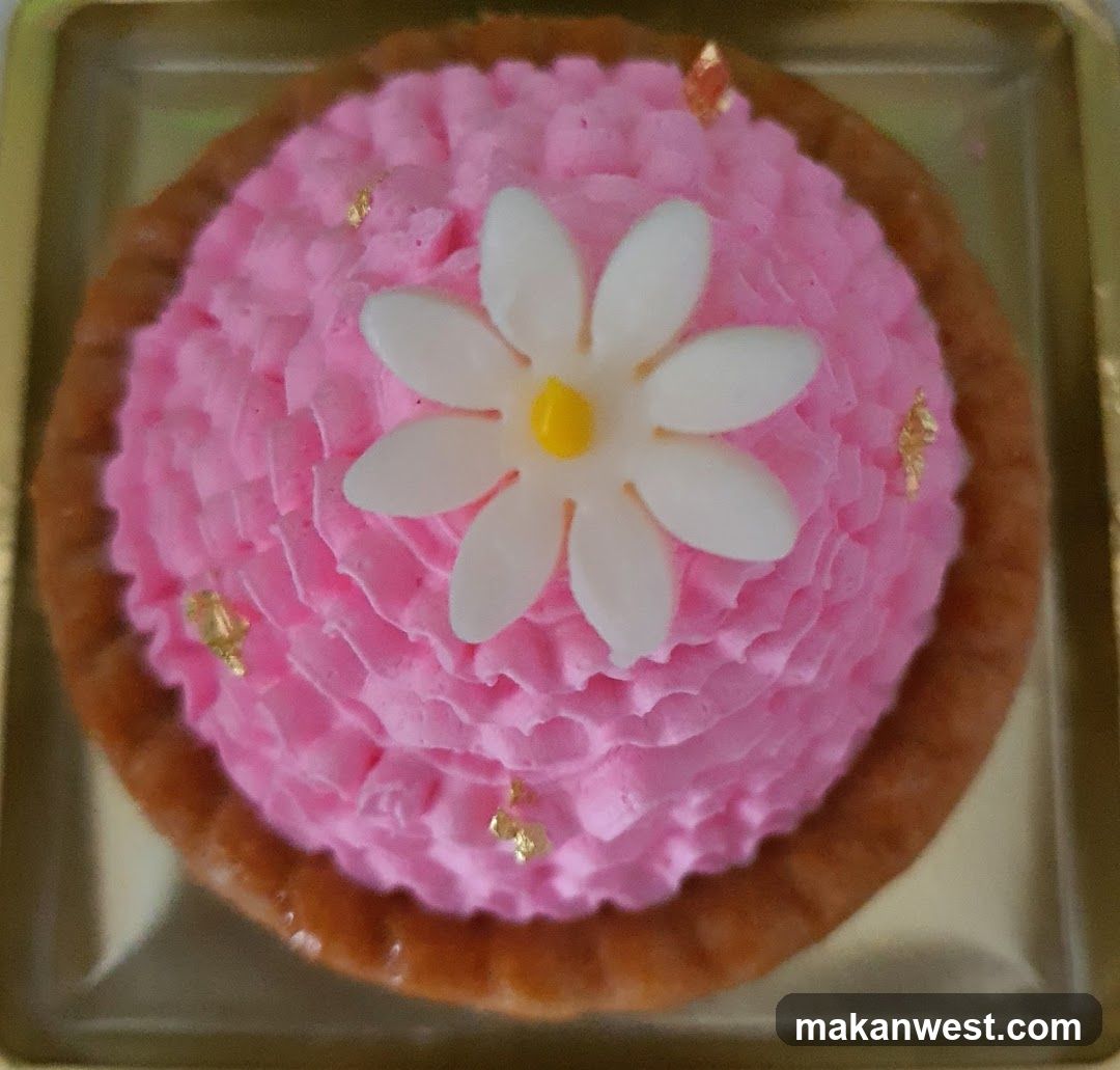 Pink Cream Tart with White Flower Decoration