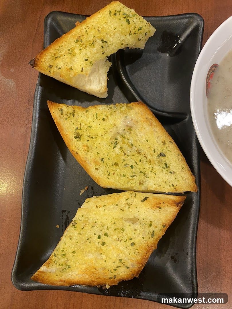 Garlic Bread Slices on Black Plate
