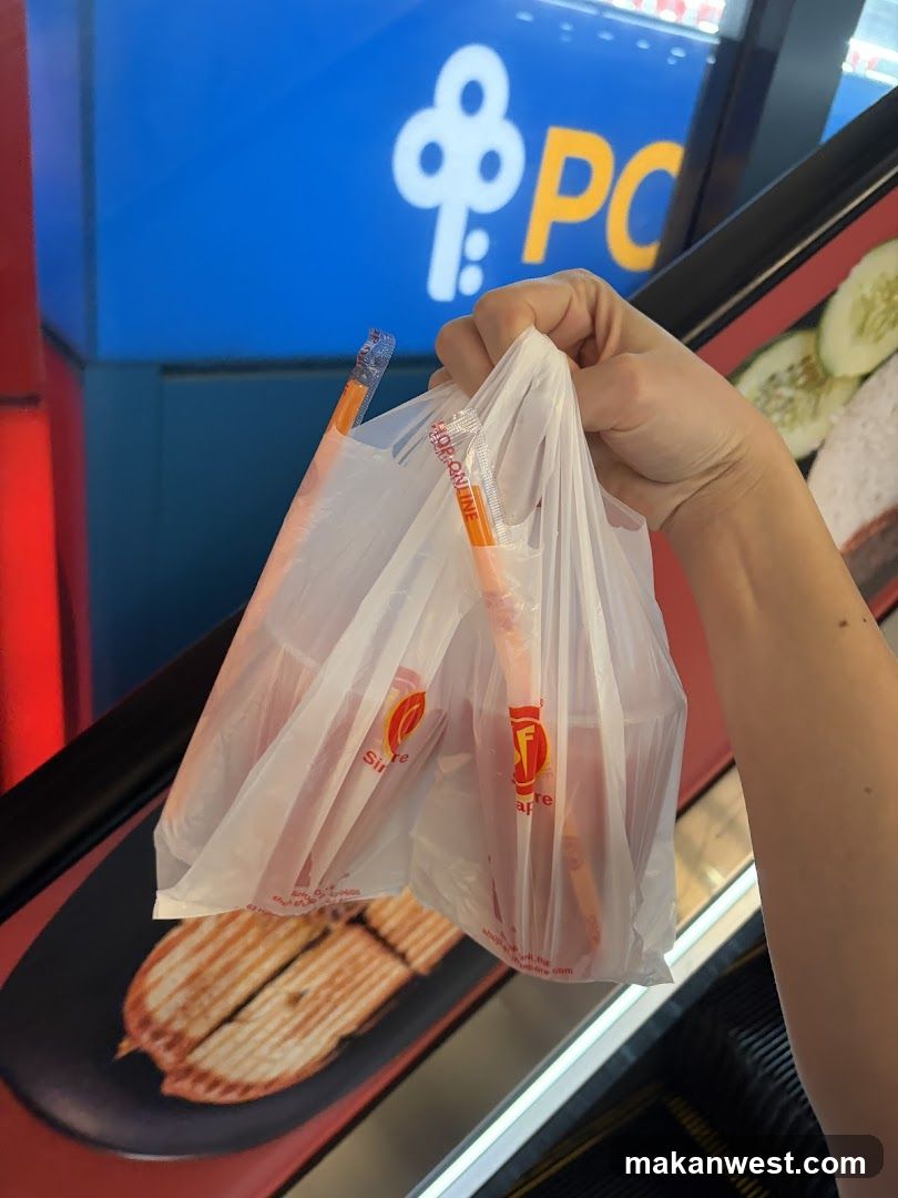 Hand holding plastic bags with food items