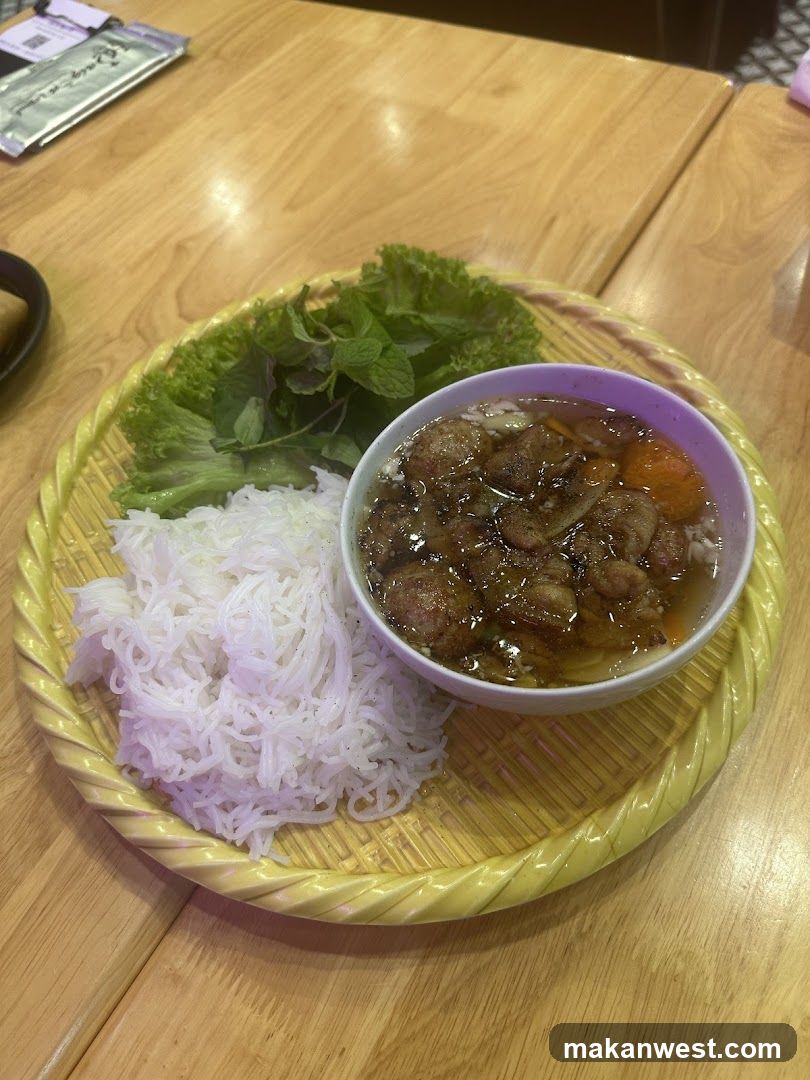 Bowl of meatballs with rice noodles and herbs