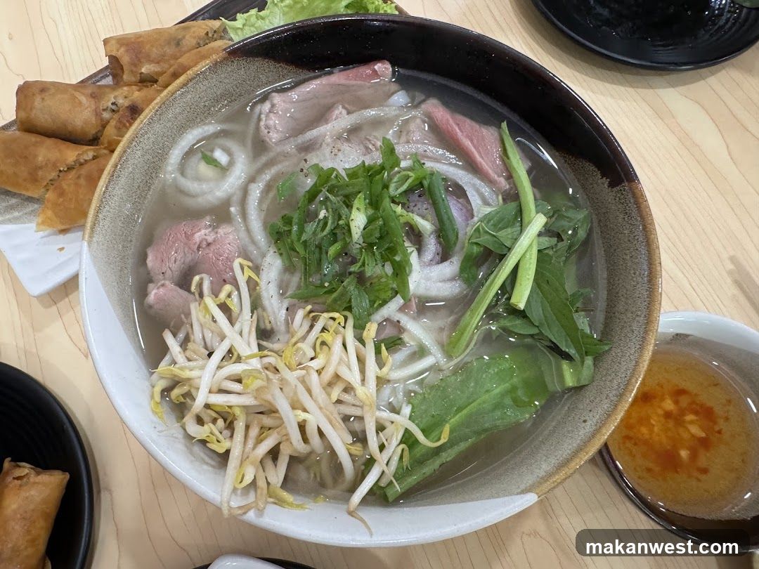Bowl of Pho with Spring Rolls and Dipping Sauce