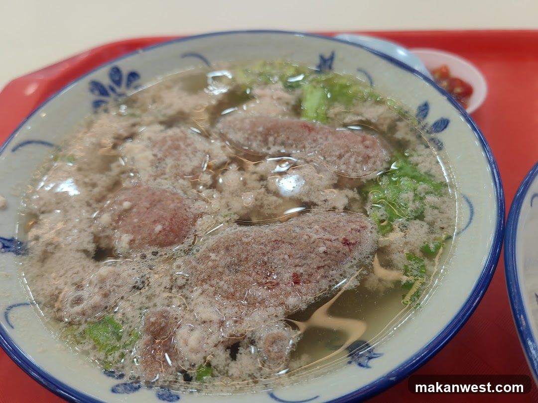 Bowl of Soup with Meatballs and Greens
