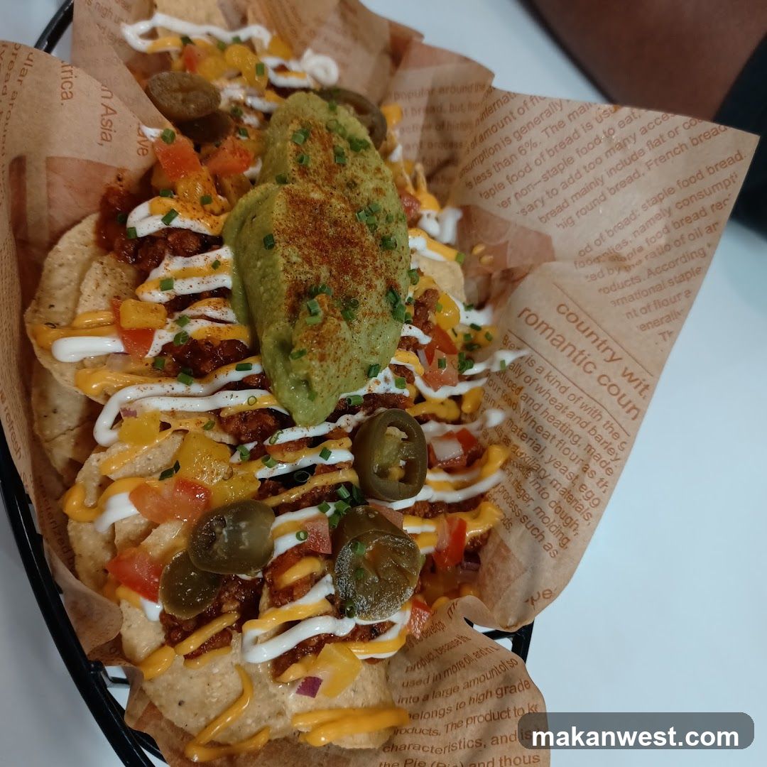 Loaded Nachos with Guacamole and Jalapeños
