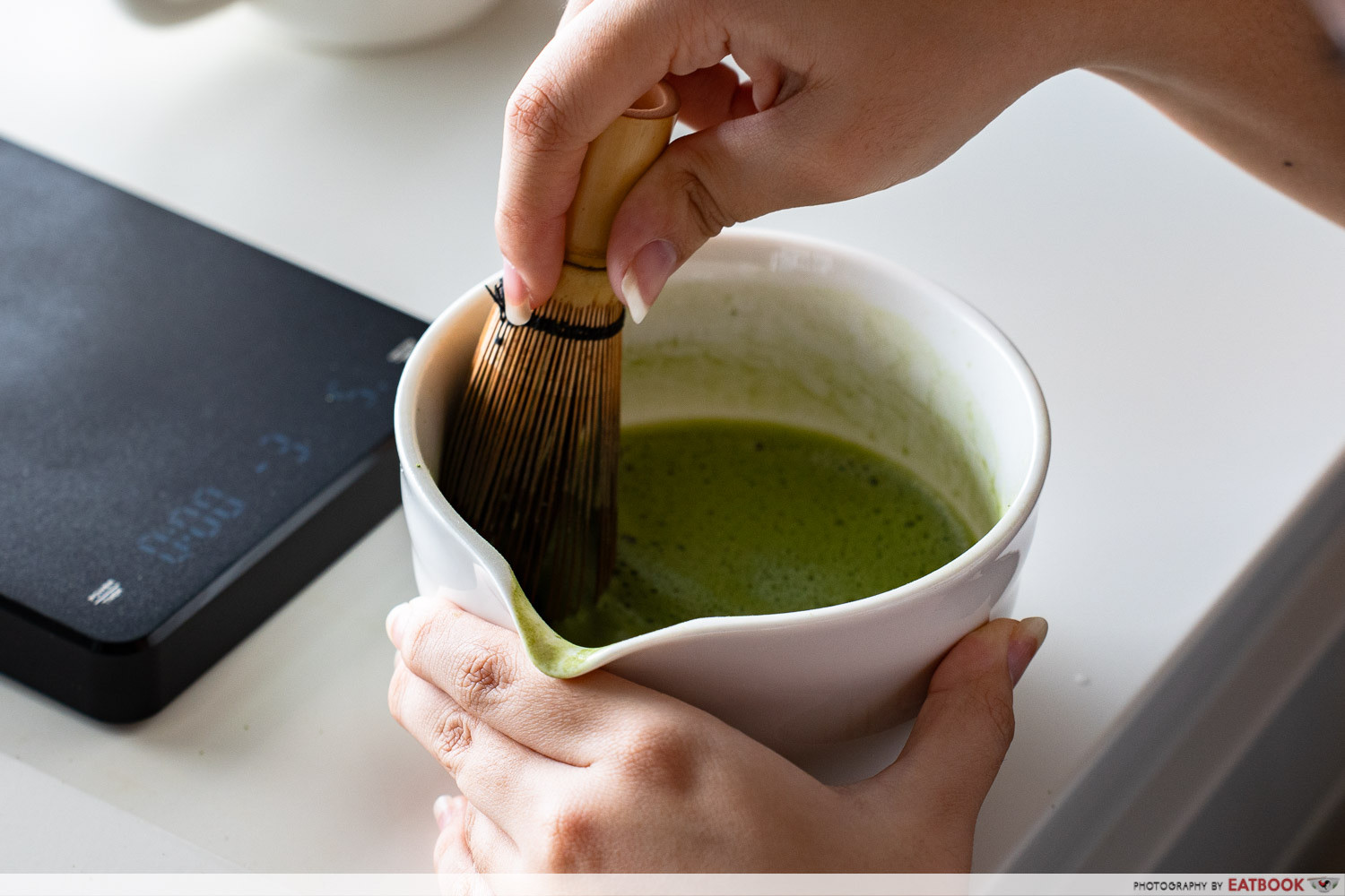 Davine whisking matcha at Brewed by Davine in Bukit Batok